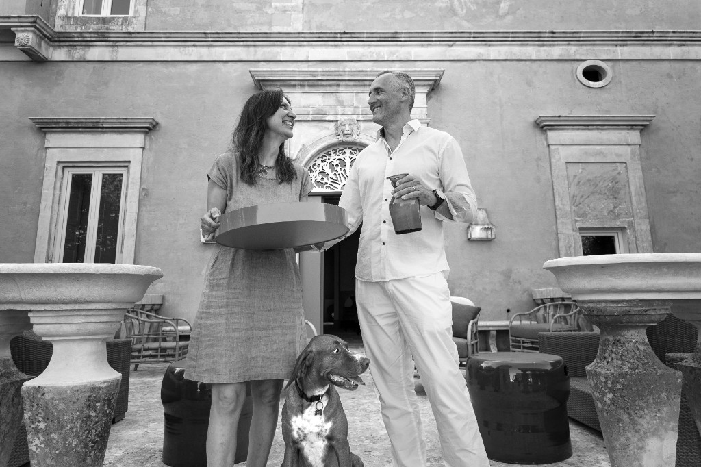 Gabriela and Elio in the courtyard of Palazzo Ceraselli with their dog