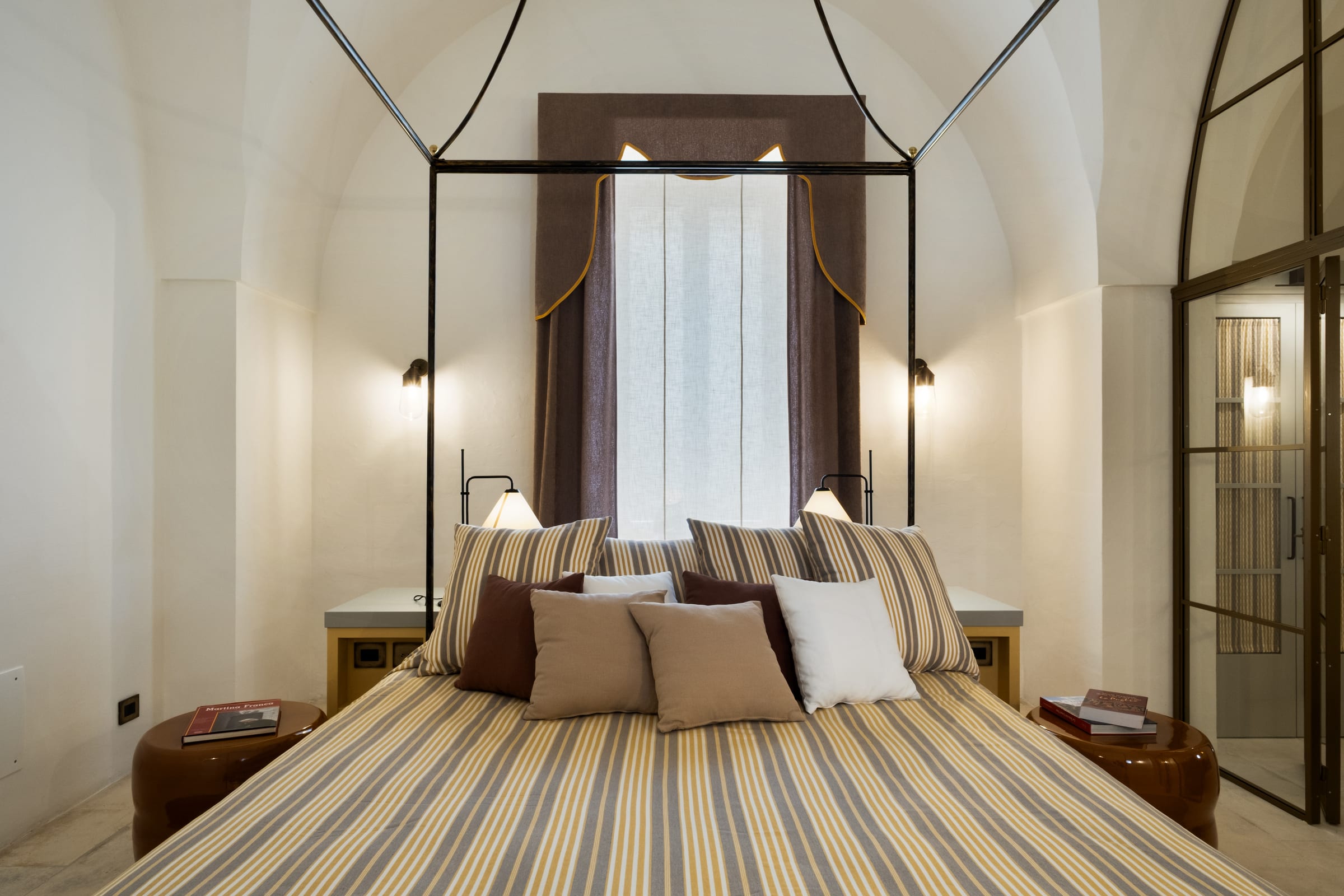 Horrea Caeli suite with canopy bed in soft natural light